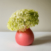 Beautiful pale green hydrangea flowers in a pink ceramic vase, ideal for home decoration and floral arrangements.