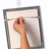 3M Command® Wire Back Picture Hanger – Damage-Free Hanging. showing back of picture along with hook on the wall.
