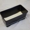 Black plastic paint scuttle with reinforced handle and ridged inner base 25l with paint in scuttle.